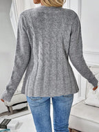 Back view of a grey cable knit cardigan with a ribbed hem
