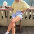 Lemon yellow short sleeve cardigan with blue shorts