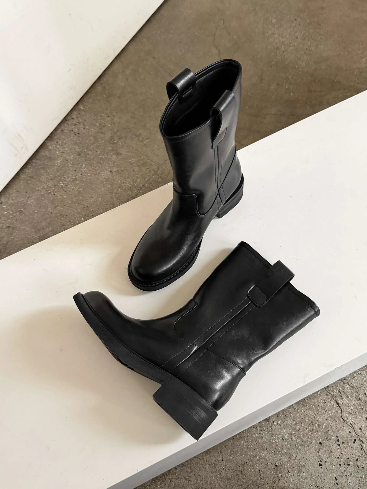 Black leather mid calf western boots with round toe and square heel