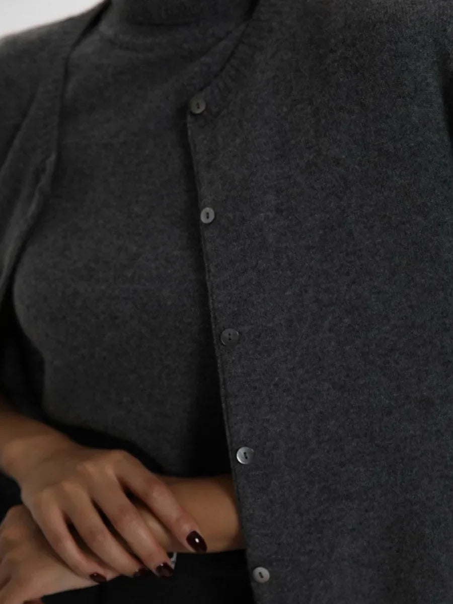 Close-up of the knit texture of a charcoal cardigan