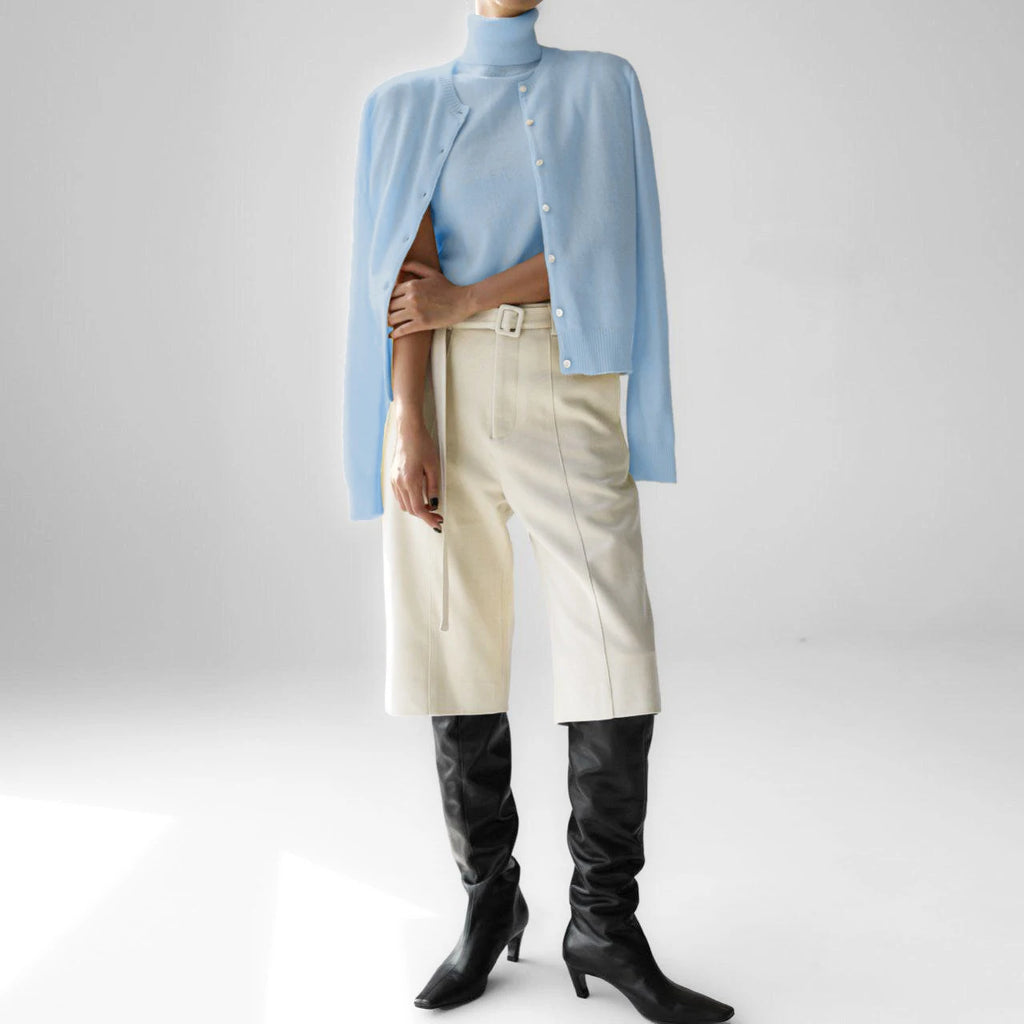 Pale blue knit tank and cardigan set styled with trousers and boots