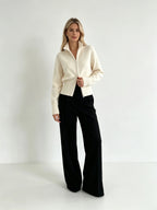 Ivory zip up cardigan with black wide-leg trousers, full-length view