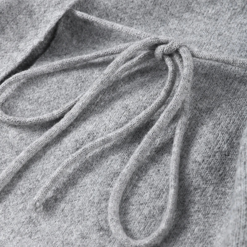 Close-up of the side tie on a grey knit cardigan
