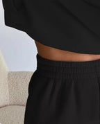 Black half button stand collar sweatshirt and jogger pants set, waistband detail