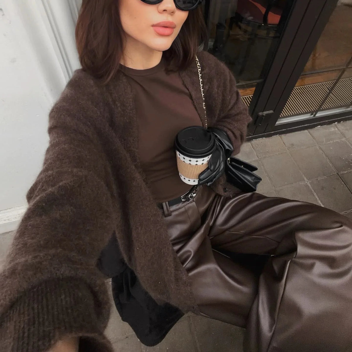 Chocolate brown knit cardigan worn with leather trousers