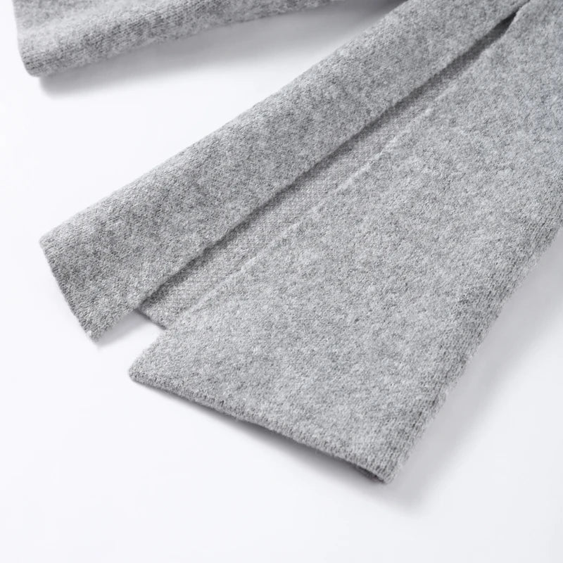 Close-up of the split flared sleeve on a grey knit cardigan