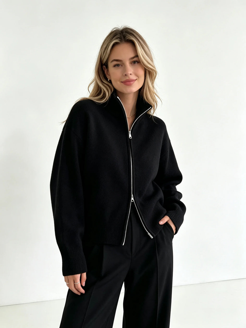 Black zip up cardigan with hands in pockets