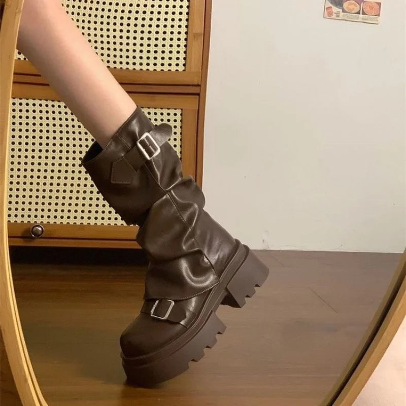 Brown slouchy platform biker boots with buckle straps, side view