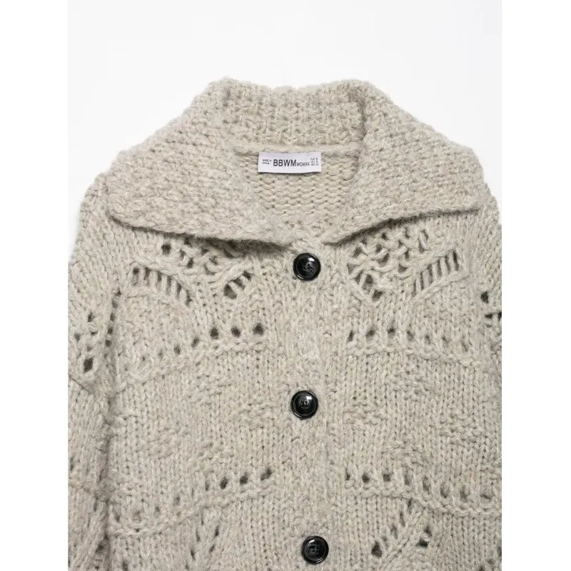 Close-up of the wide collar and black buttons on an oatmeal knit cardigan