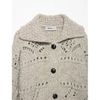 Close-up of the wide collar and black buttons on an oatmeal knit cardigan