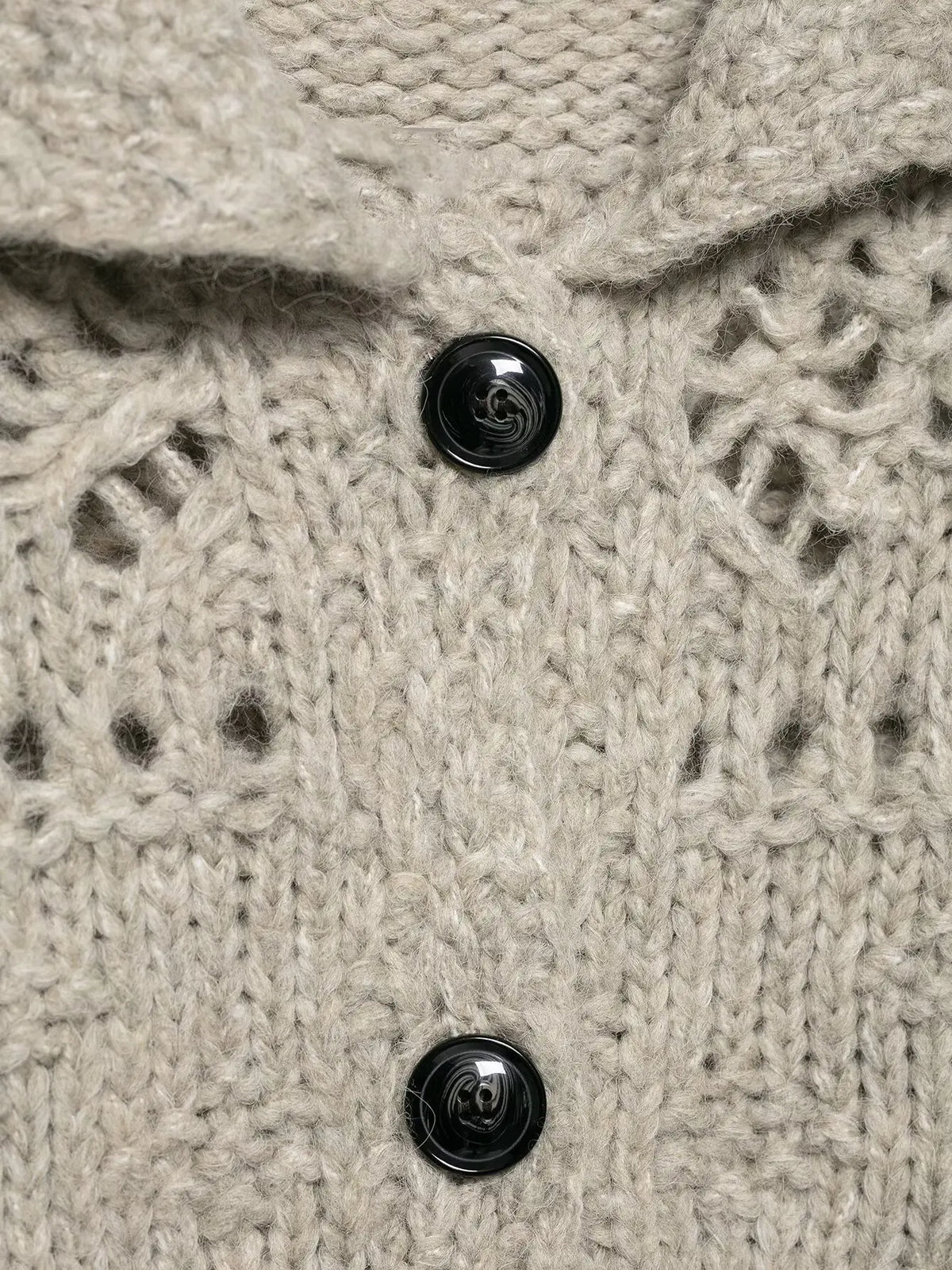 Close-up of the open knit stitch and black buttons