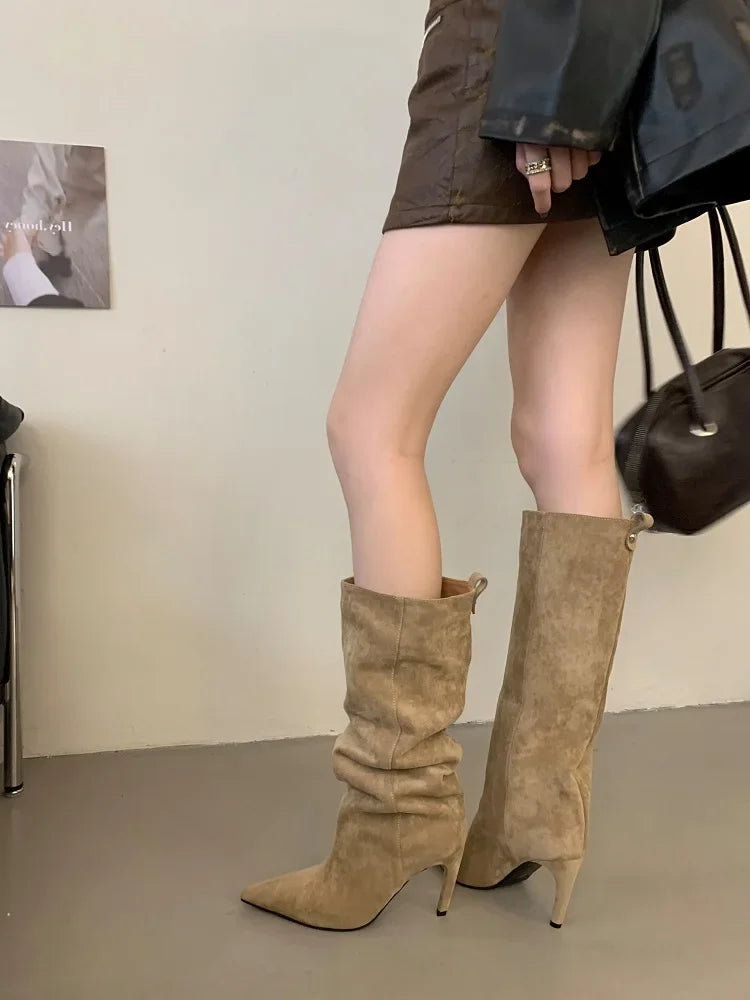 Sand flock slouch knee high boots with pointed toe and thin heel, worn