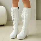 White lace-up chunky platform boots, worn side by side