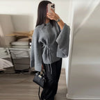 Grey tie side knit cardigan, front view with black trousers
