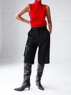Red roll neck knit tank styled with shorts and boots