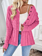 Hot pink cable knit button cardigan worn off the shoulder