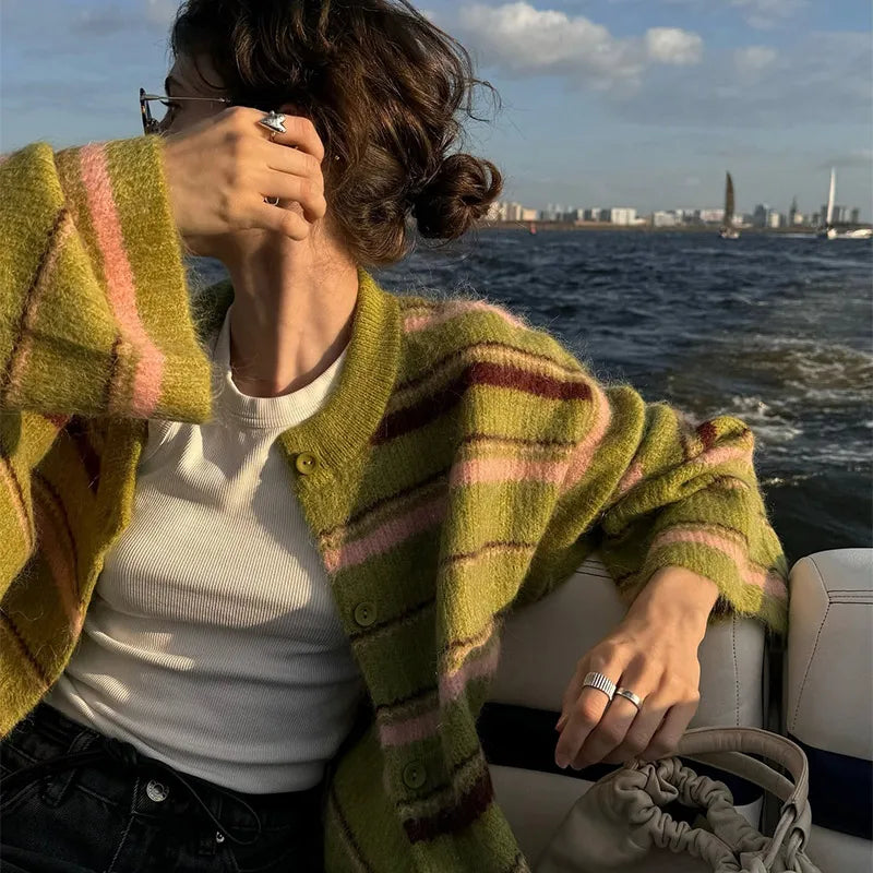 Olive green striped cardigan with pink and brown stripes, worn open