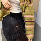 Olive green striped cardigan worn with a black lace skirt