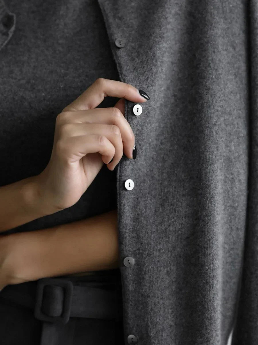 Close-up of the buttons on a charcoal knit cardigan
