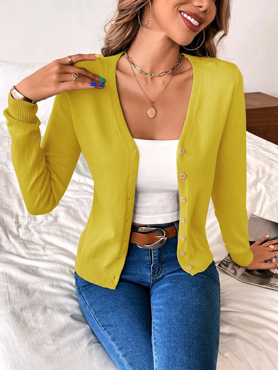 Mustard yellow V neck button cardigan with a white cami and jeans