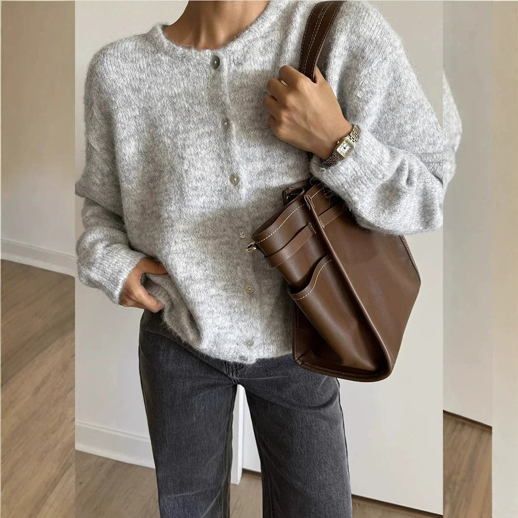 Light grey button front cardigan worn with jeans