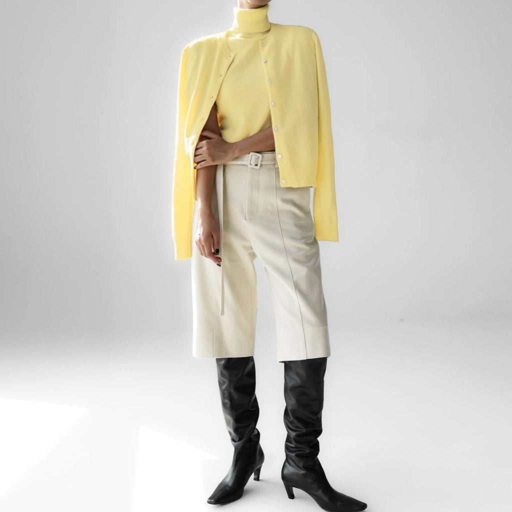 Lemon yellow knit tank and cardigan set styled with trousers and boots