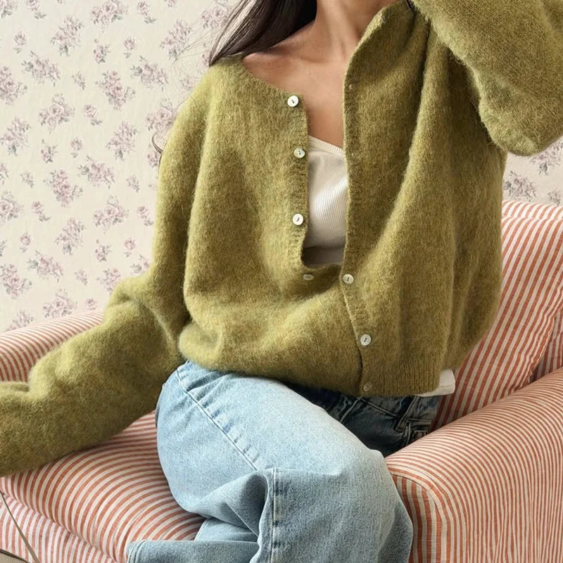 Moss green button cardigan worn over a white top