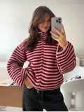 Burgundy and pink striped zip up cardigan, worn with black jeans