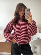 Burgundy and pink striped zip up cardigan, worn with black jeans