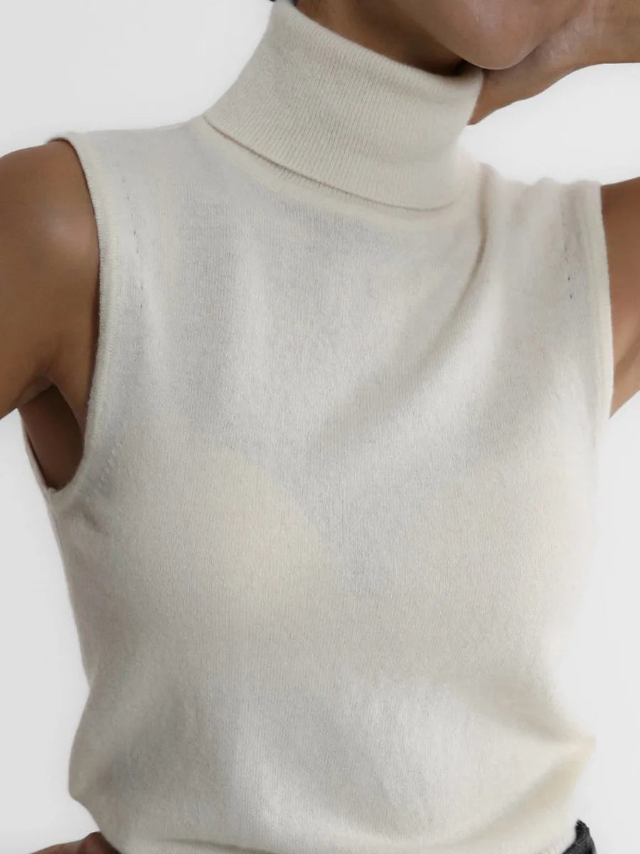 Close-up of the roll neck on a cream sleeveless knit tank