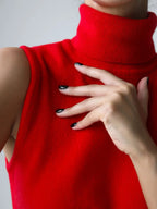 Close-up of a red roll neck sleeveless knit tank