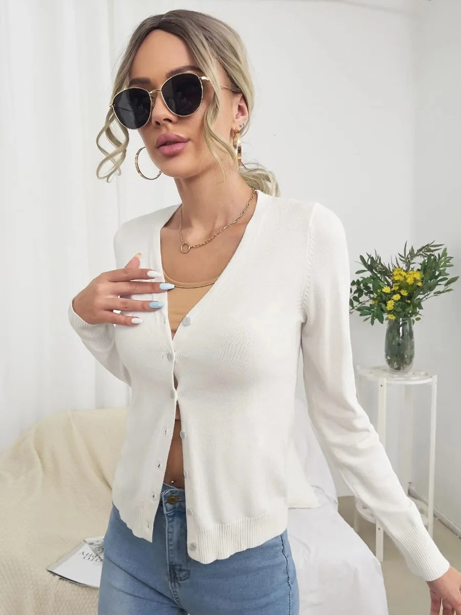 White V neck button cardigan styled with sunglasses and jeans