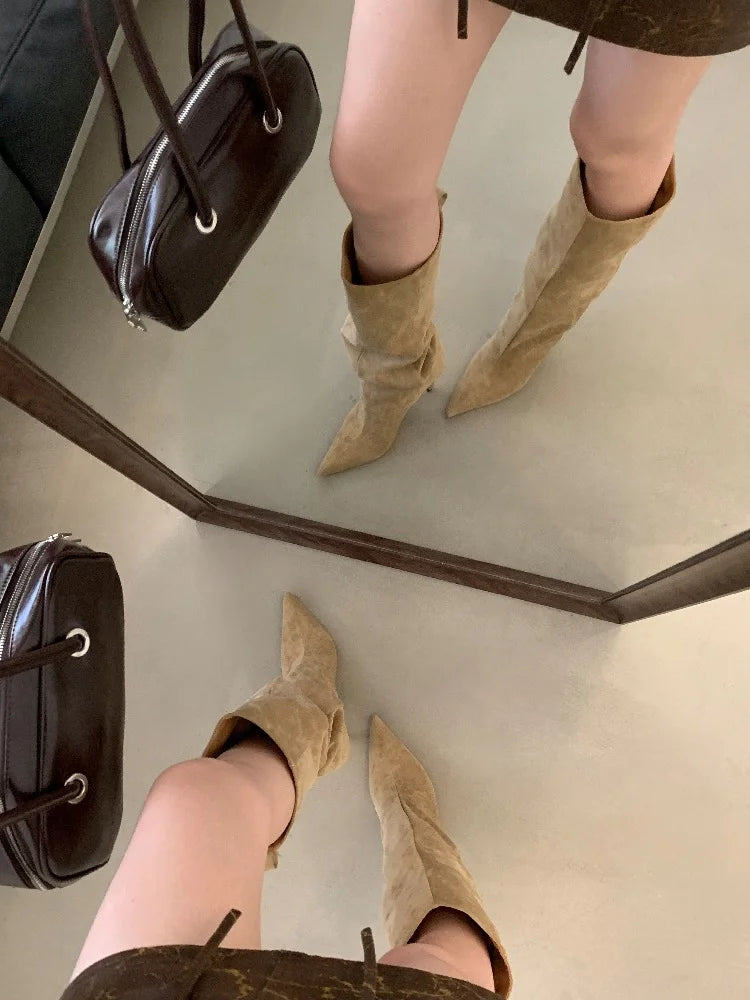 Sand flock slouch knee high boots with pointed toe and thin heel, worn