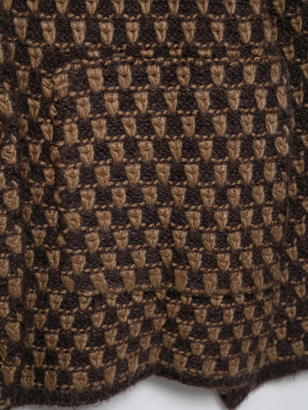 Close-up of the check knit stitch and patch pocket