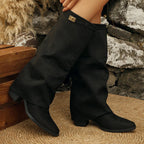 Black fold over boots with metal buckle, worn seated
