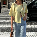 Lemon yellow short sleeve cardigan worn open with light blue jeans