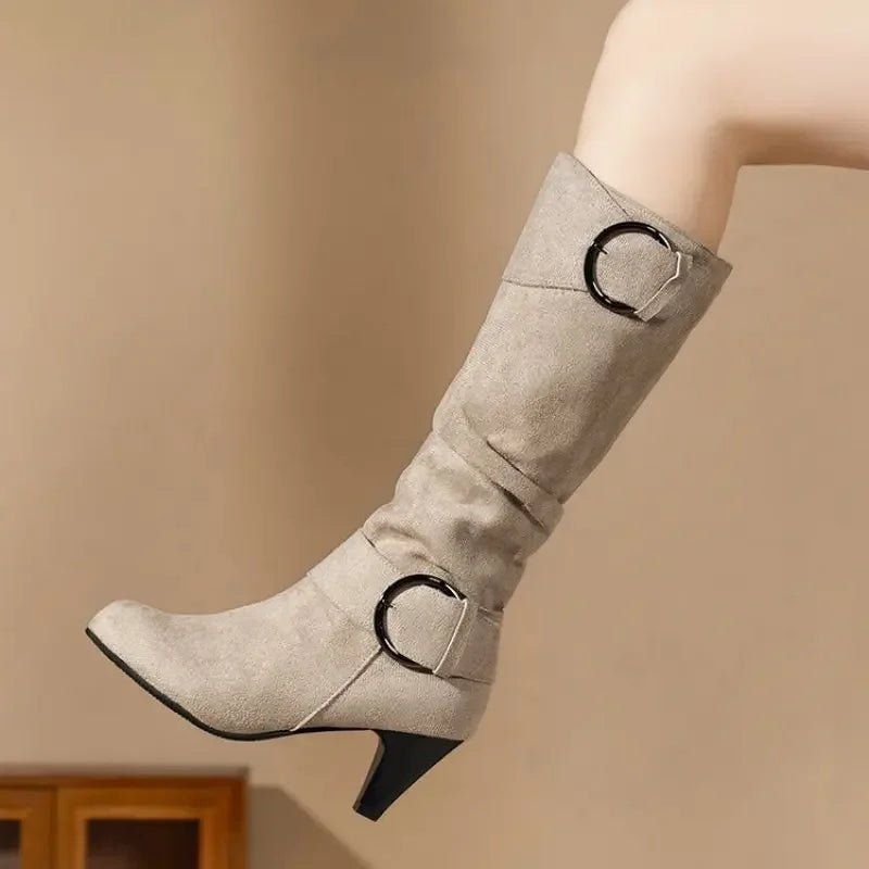 Beige slouchy heeled boot with ring buckle strap, side view