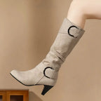 Beige slouchy heeled boot with ring buckle strap, side view