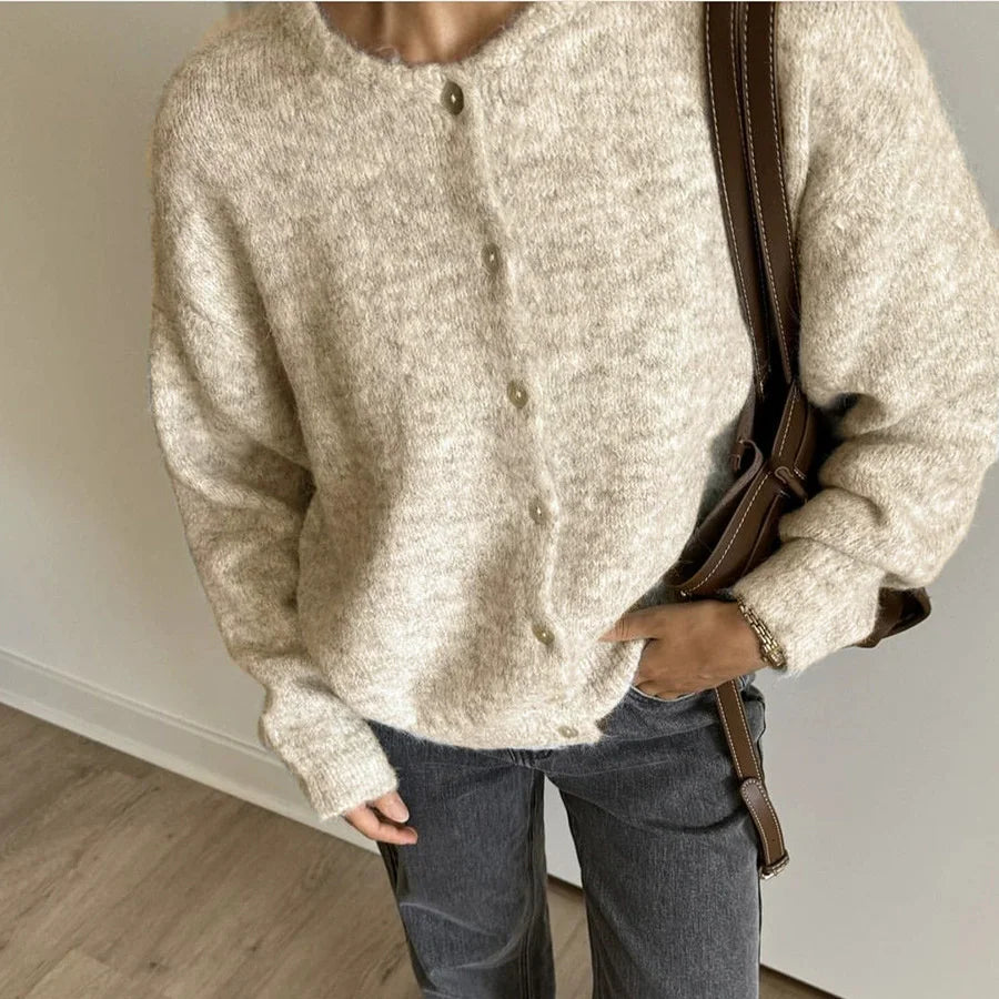 Oatmeal button front cardigan worn with grey jeans