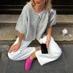 Grey short sleeve knit cardigan with white trousers