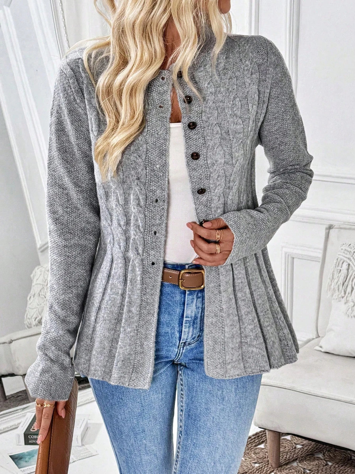 Grey cable knit button cardigan with a flared ribbed hem, front view