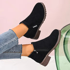 Black side zip chunky heel ankle boots worn with jeans