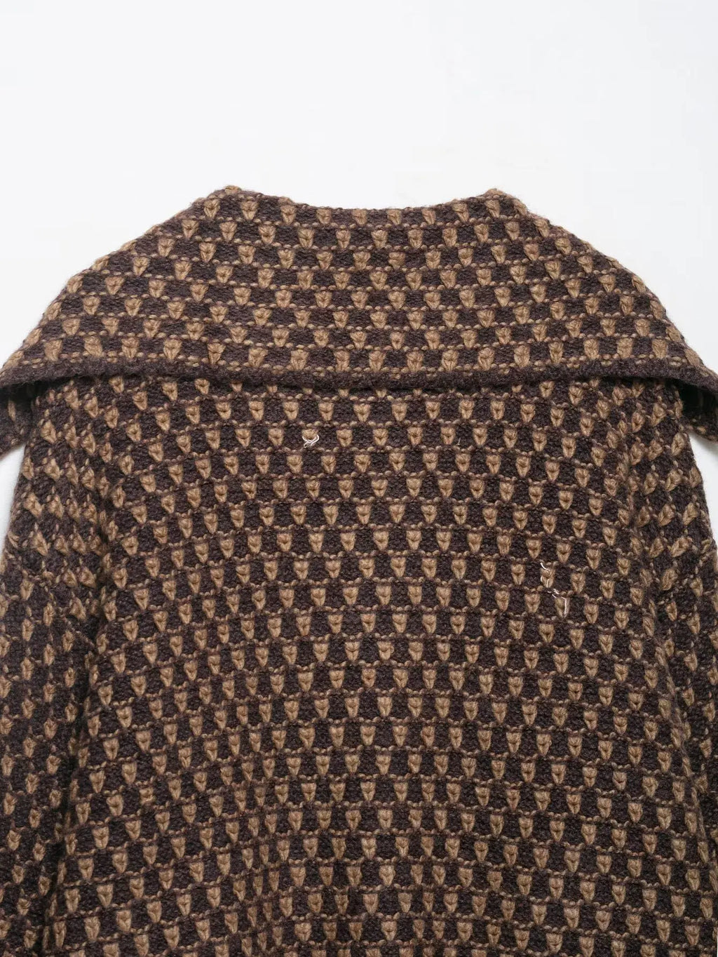 Back collar detail of a brown and tan check knit cardigan