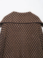 Back collar detail of a brown and tan check knit cardigan
