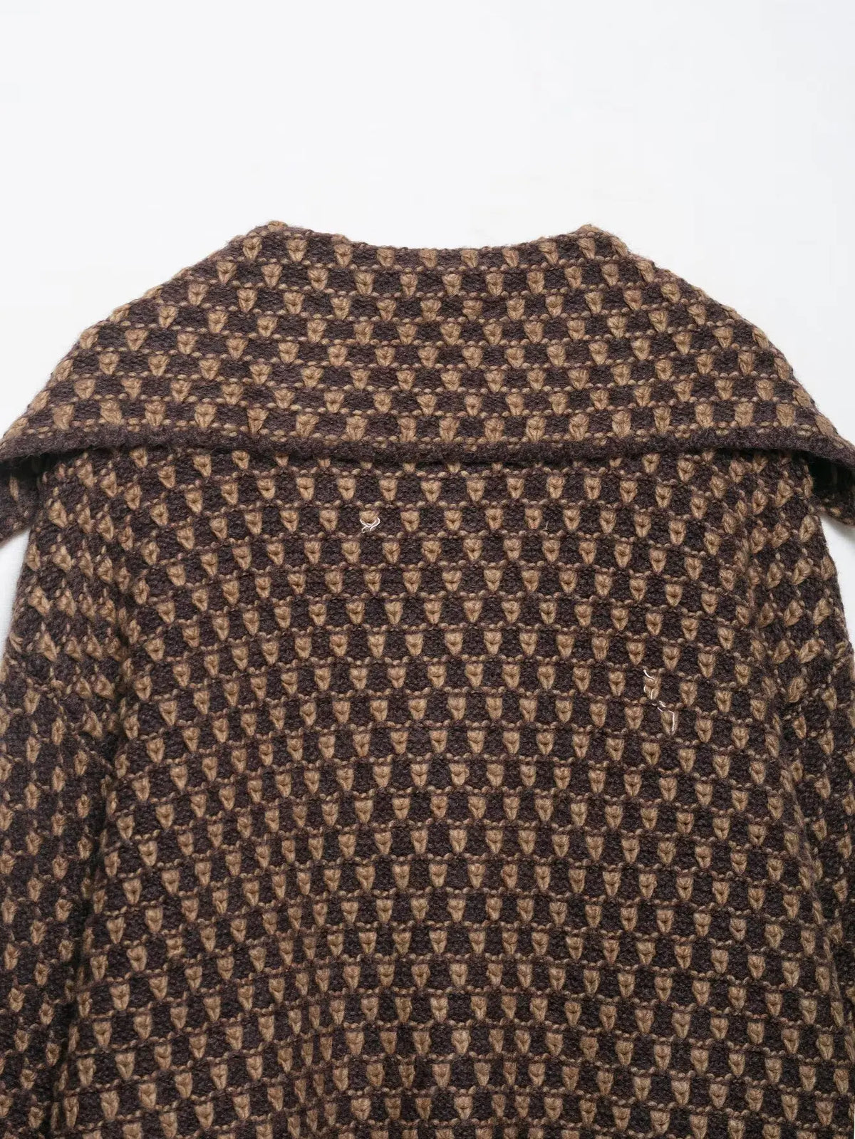 Back collar detail of a brown and tan check knit cardigan