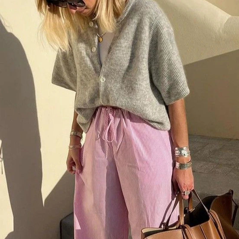 Grey short sleeve cardigan with pink striped trousers