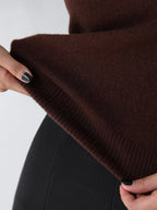Close-up of the ribbed hem on a chocolate brown knit cardigan