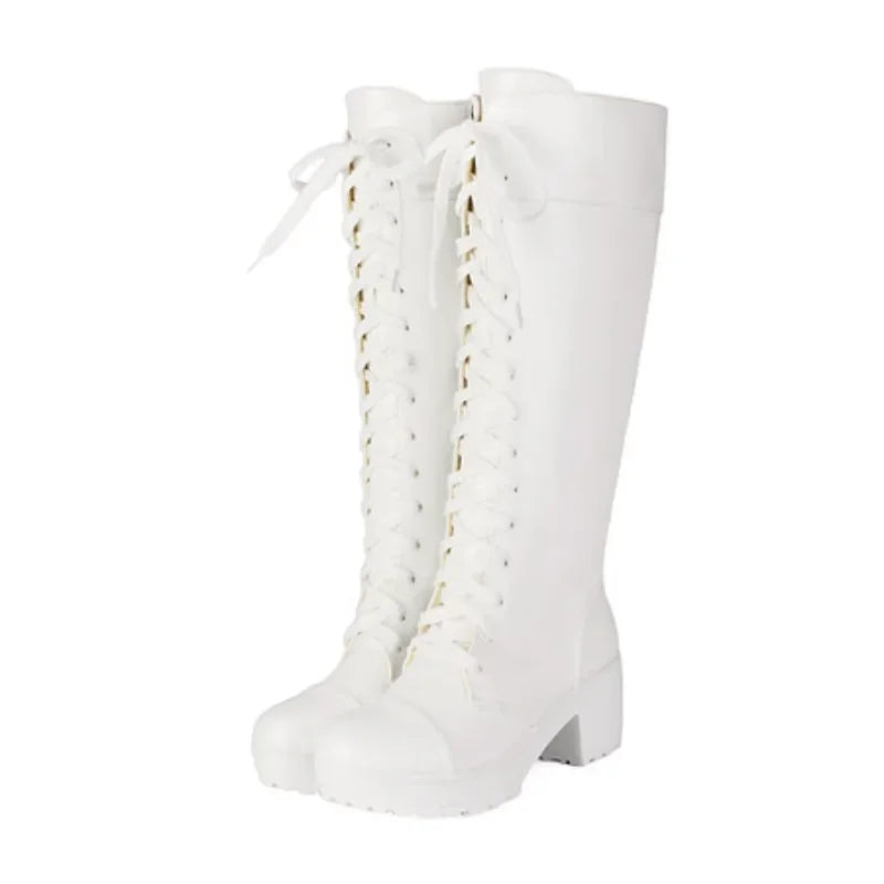 White lace-up knee high platform boots on a white background