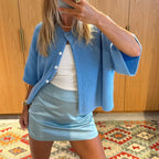 Sky blue short sleeve button cardigan with a light blue skirt
