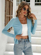 Sky blue V neck button cardigan worn with a white cami and jeans